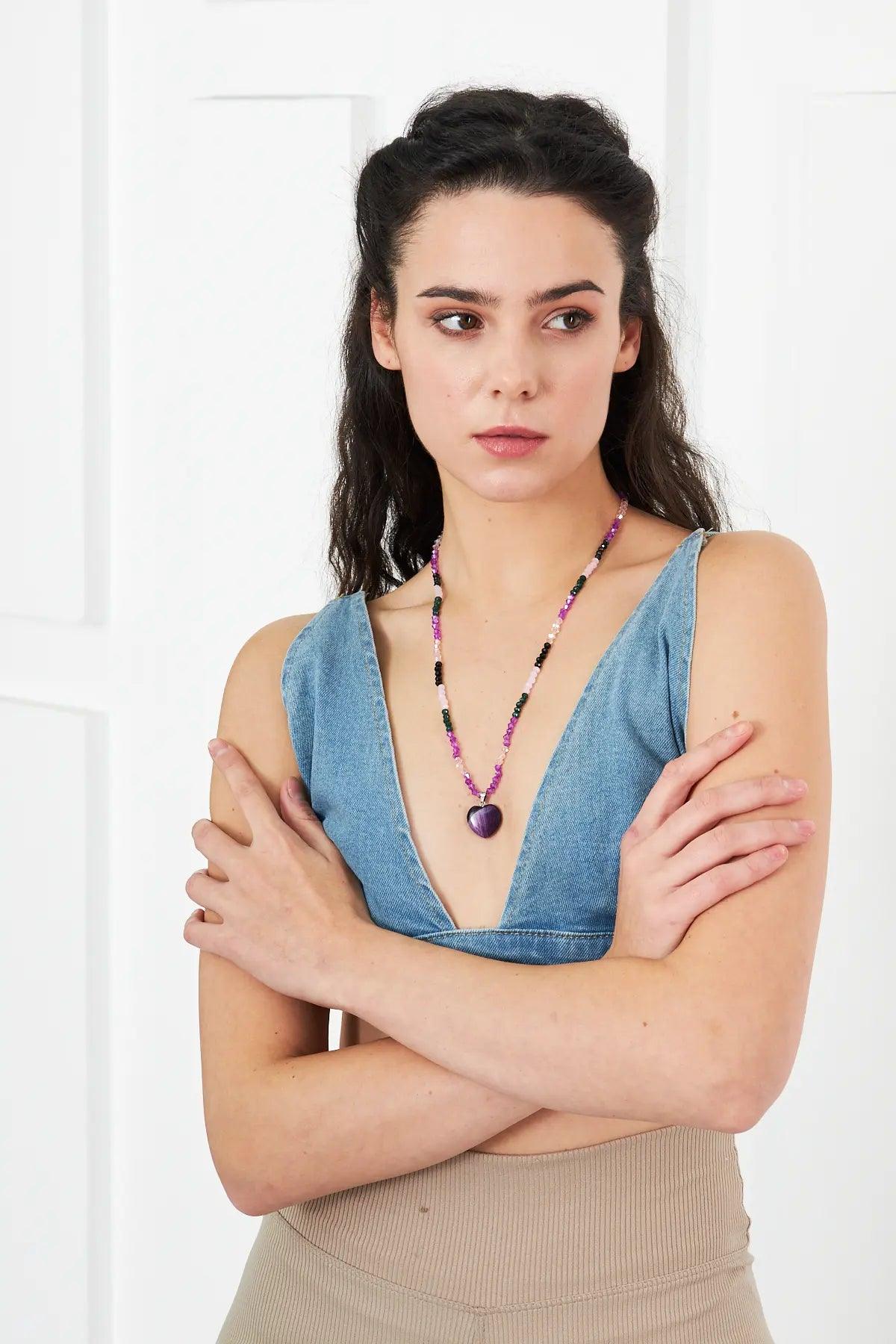 A stunning necklace featuring an amethyst heart-shaped pendant with faceted crystal beads in purple and pink tones, perfect for adding elegance to any outfit.