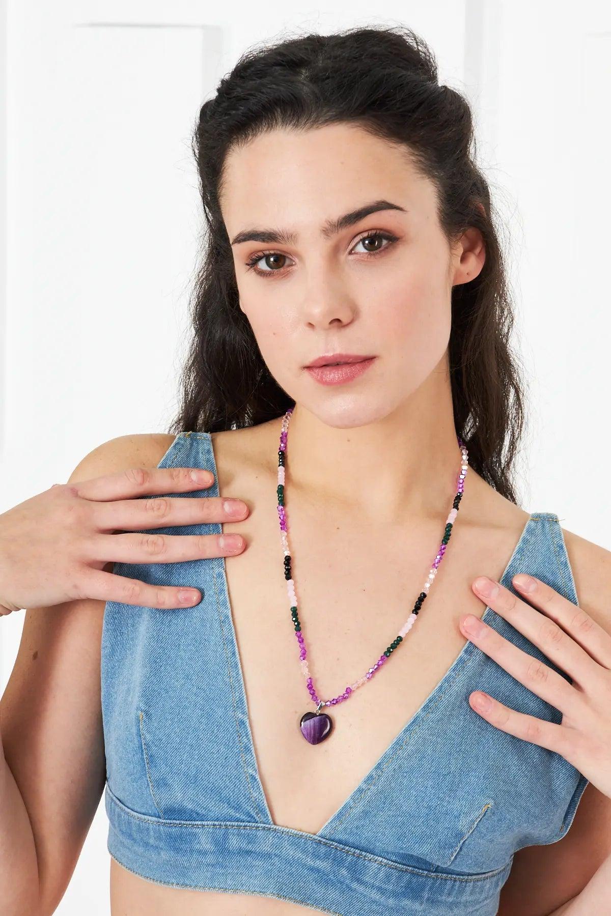 A stunning necklace featuring an amethyst heart-shaped pendant with faceted crystal beads in purple and pink tones, perfect for adding elegance to any outfit.